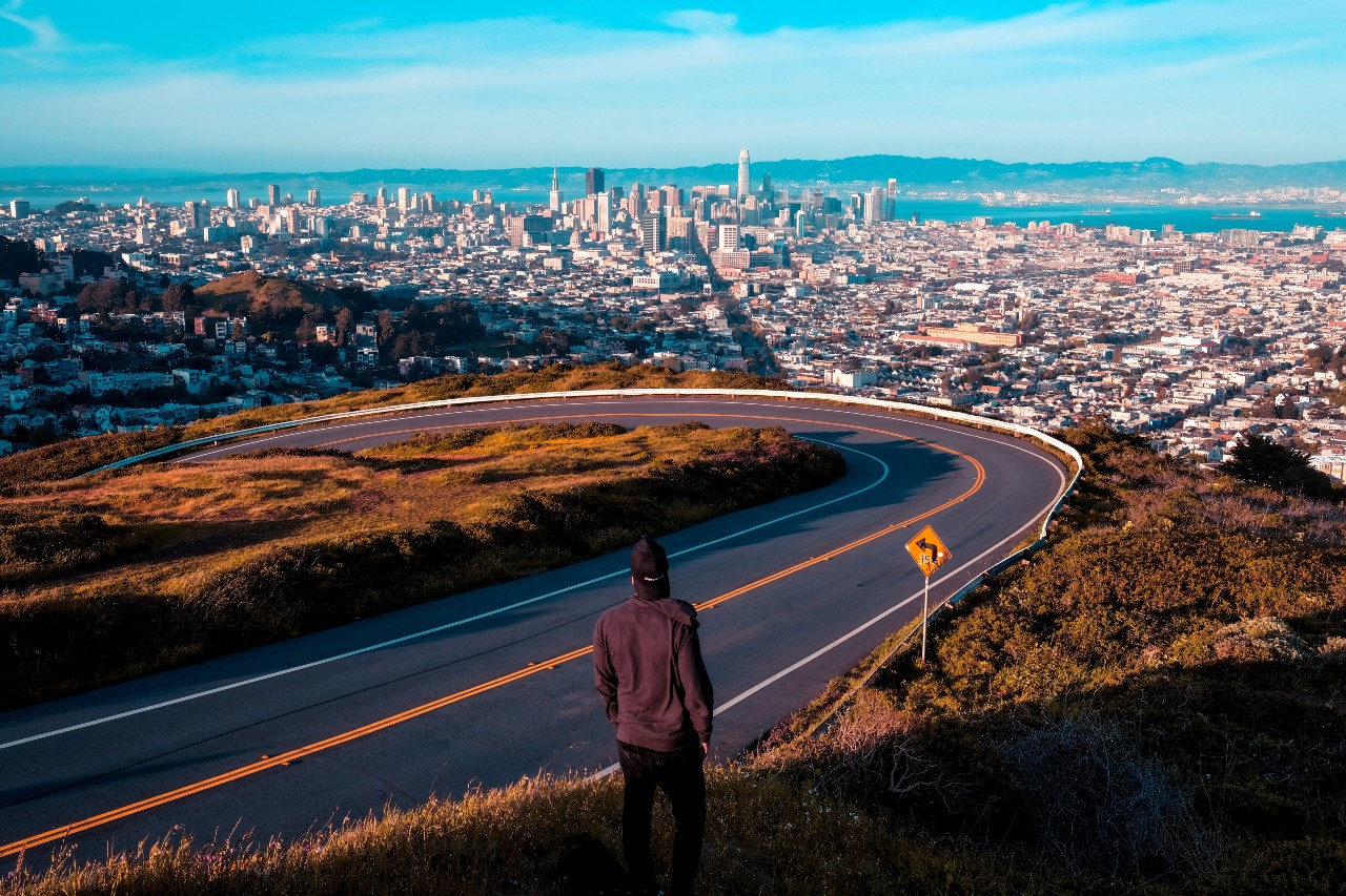 Man Standing over San Francisco city line on a cliff