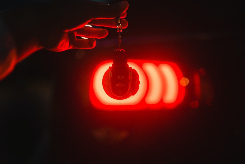 Car key in front of red light silhouette